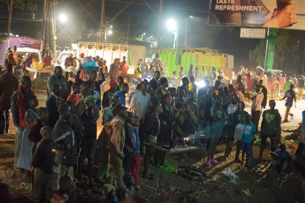 Street children, business owners and buyers watching the Ekegusii Jesus Film
